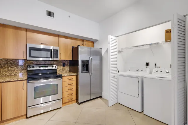 a kitchen with cabinets stainless steel appliances and sink