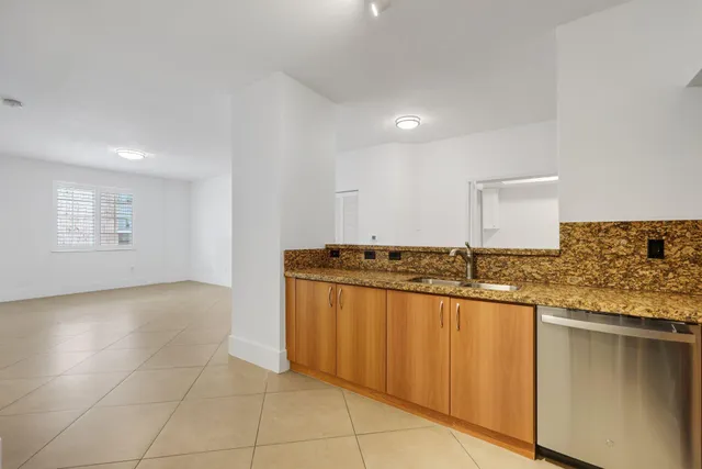 a kitchen with stainless steel appliances granite countertop a sink and cabinets