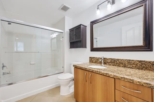 a living room with furniture and a dining table with wooden floor