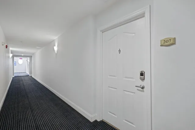 a view of hallway with wooden floor
