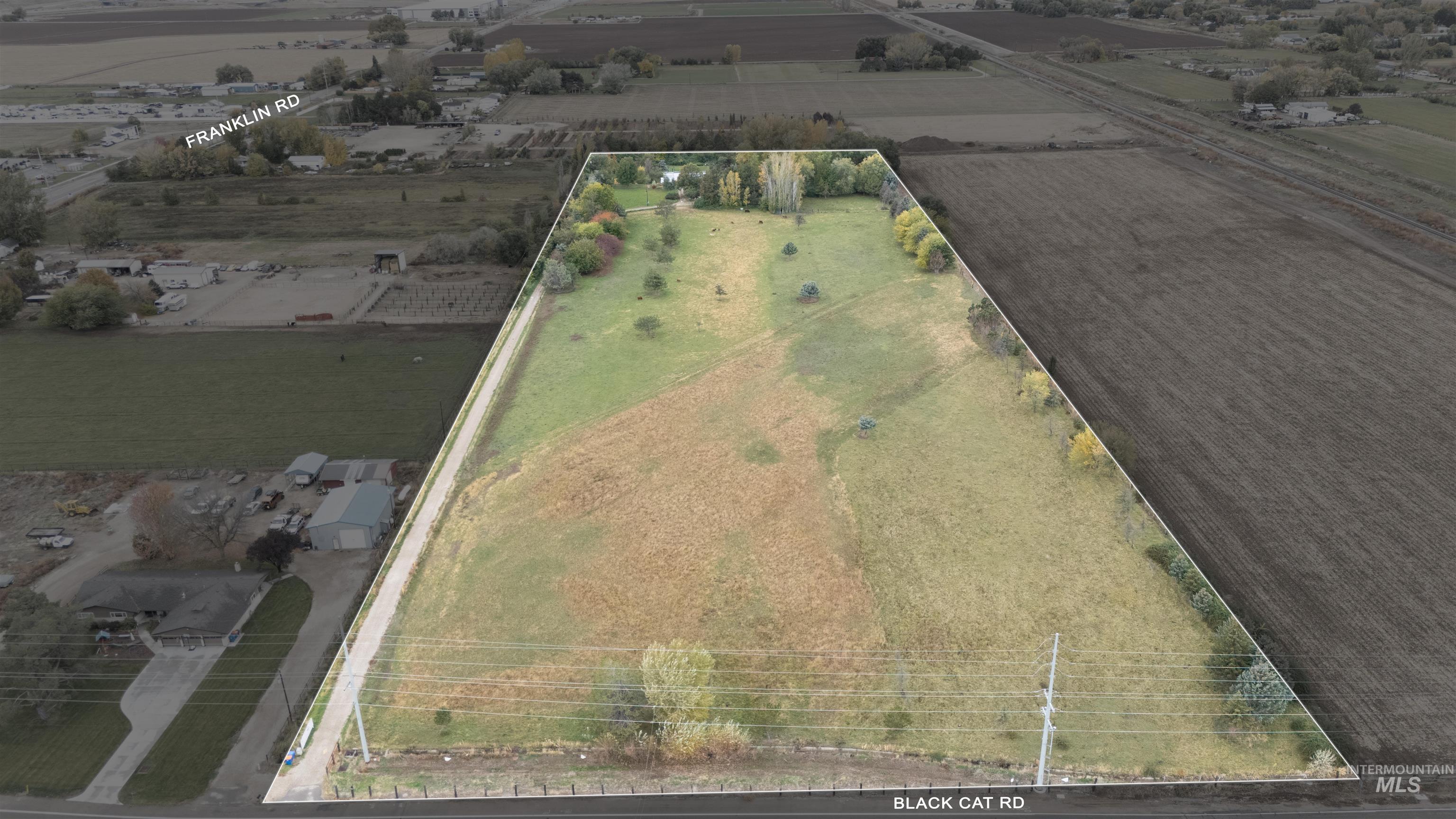 225 North Black Cat Road Meridian, ID 83642 - Photo 2 of 2 Aerial view of sparsely populated area featuring property boundaries highlighted and abundant farmland