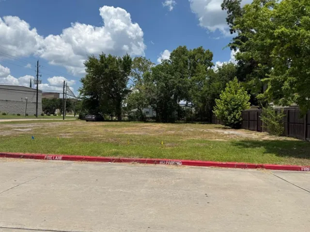 a view of a house with a big yard and large trees