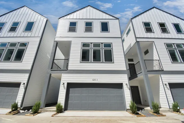 a front view of a brick house with large windows