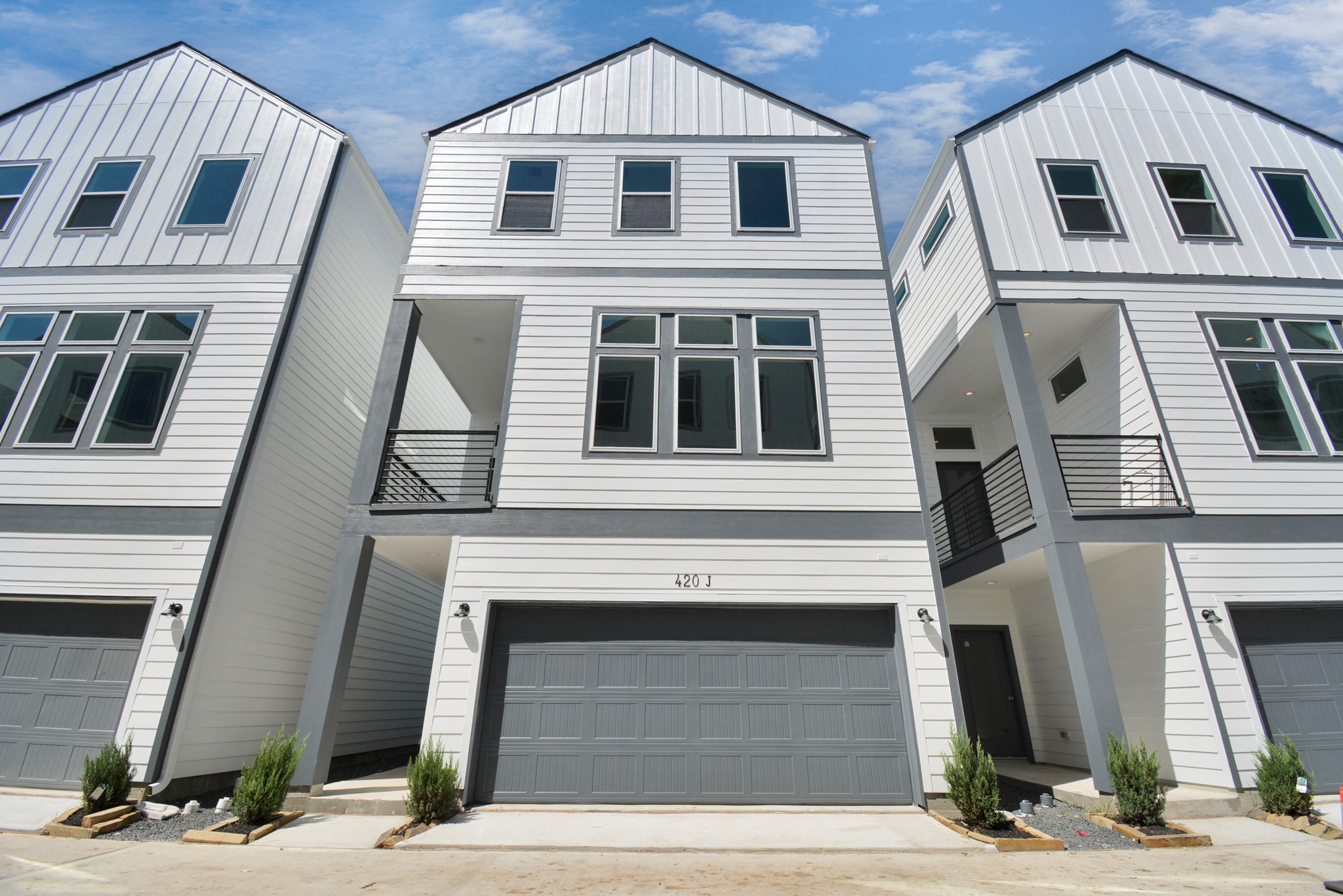 a front view of a brick house with large windows