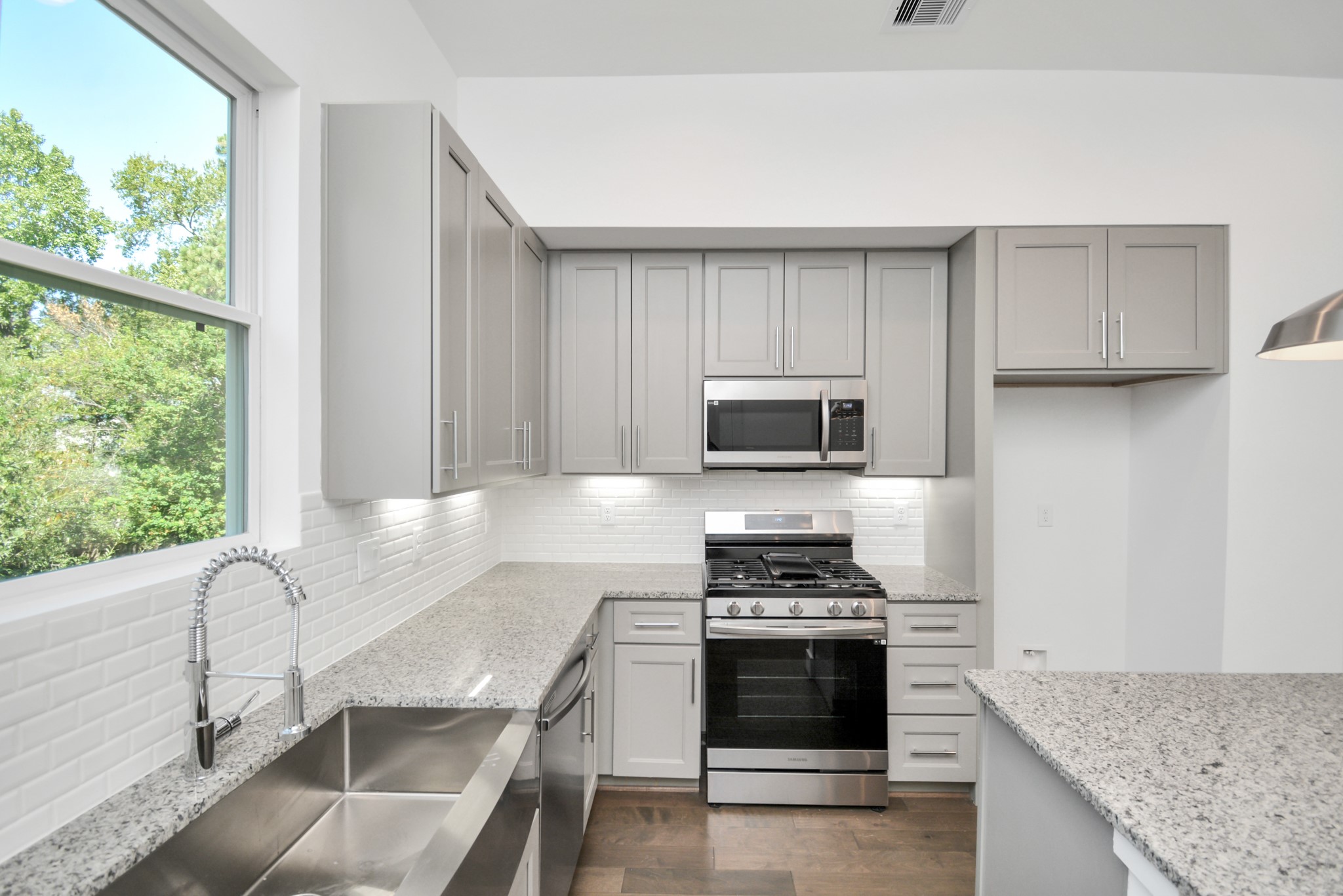 420 Janisch Road, Unit B Houston, TX 77018 - Photo 12 of 24 a kitchen with stainless steel appliances granite countertop a stove a sink and a microwave