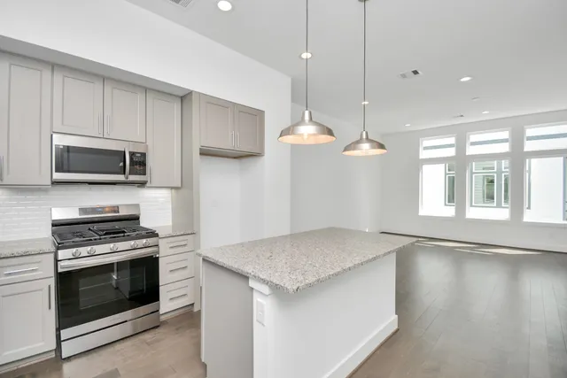a kitchen with a stove a sink and a microwave