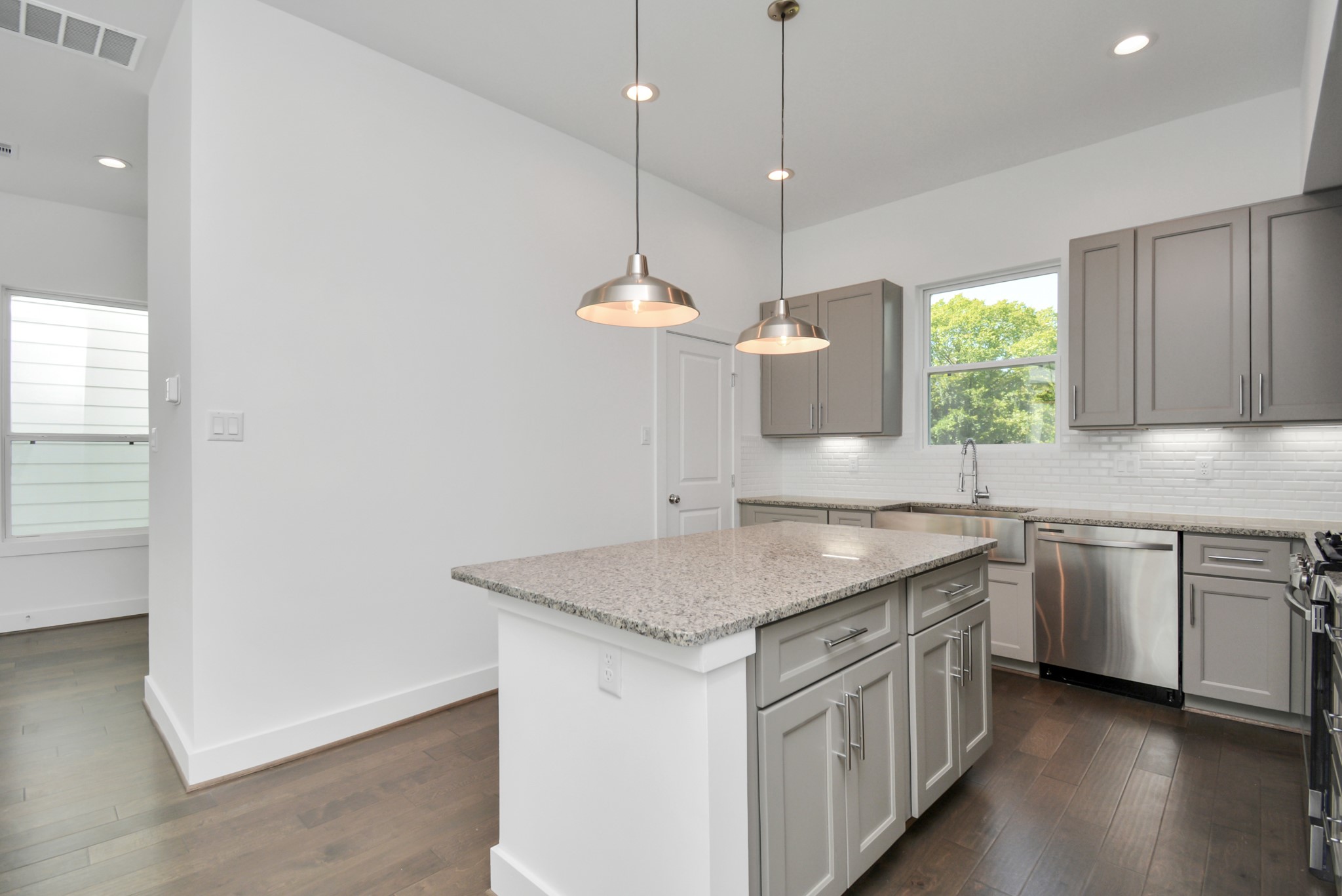 420 Janisch Road, Unit B Houston, TX 77018 - Photo 15 of 24 a kitchen with a center island wooden floor and a window