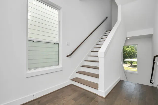 a view of entryway and hall with wooden floor