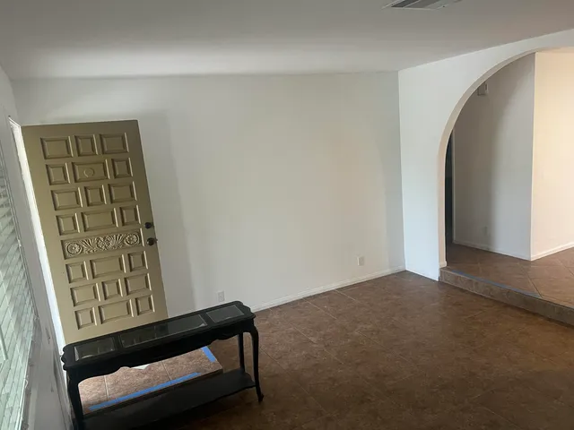 a kitchen with a sink and chairs