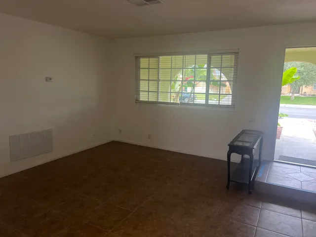 a kitchen with a sink and chairs