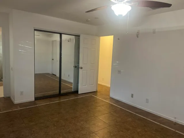 a view of a house with a tree and a yard