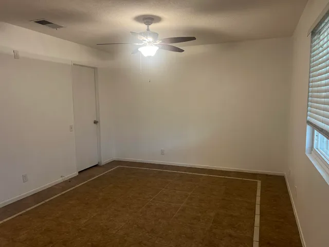 a view of a house with a yard and potted plants