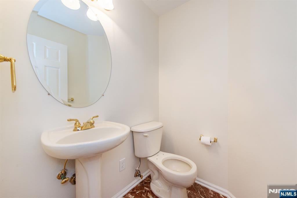 146 Summit Ridge, Unit 1406 Pompton Lakes, NJ 07442 - Photo 9 of 26 a bathroom with a sink a toilet and a mirror