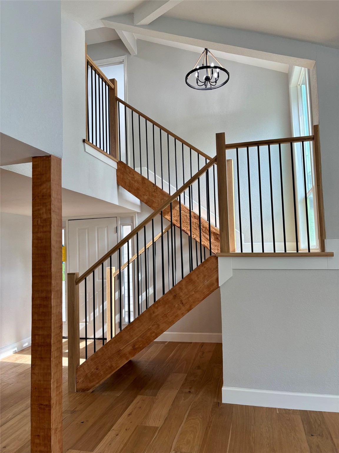 12303 Split Rail Lane Houston, TX 77071 - Photo 15 of 50 Modern black iron balusters complement the natural wood tones, creating a perfect balance of sophistication and durability that elevates the heart of the home.