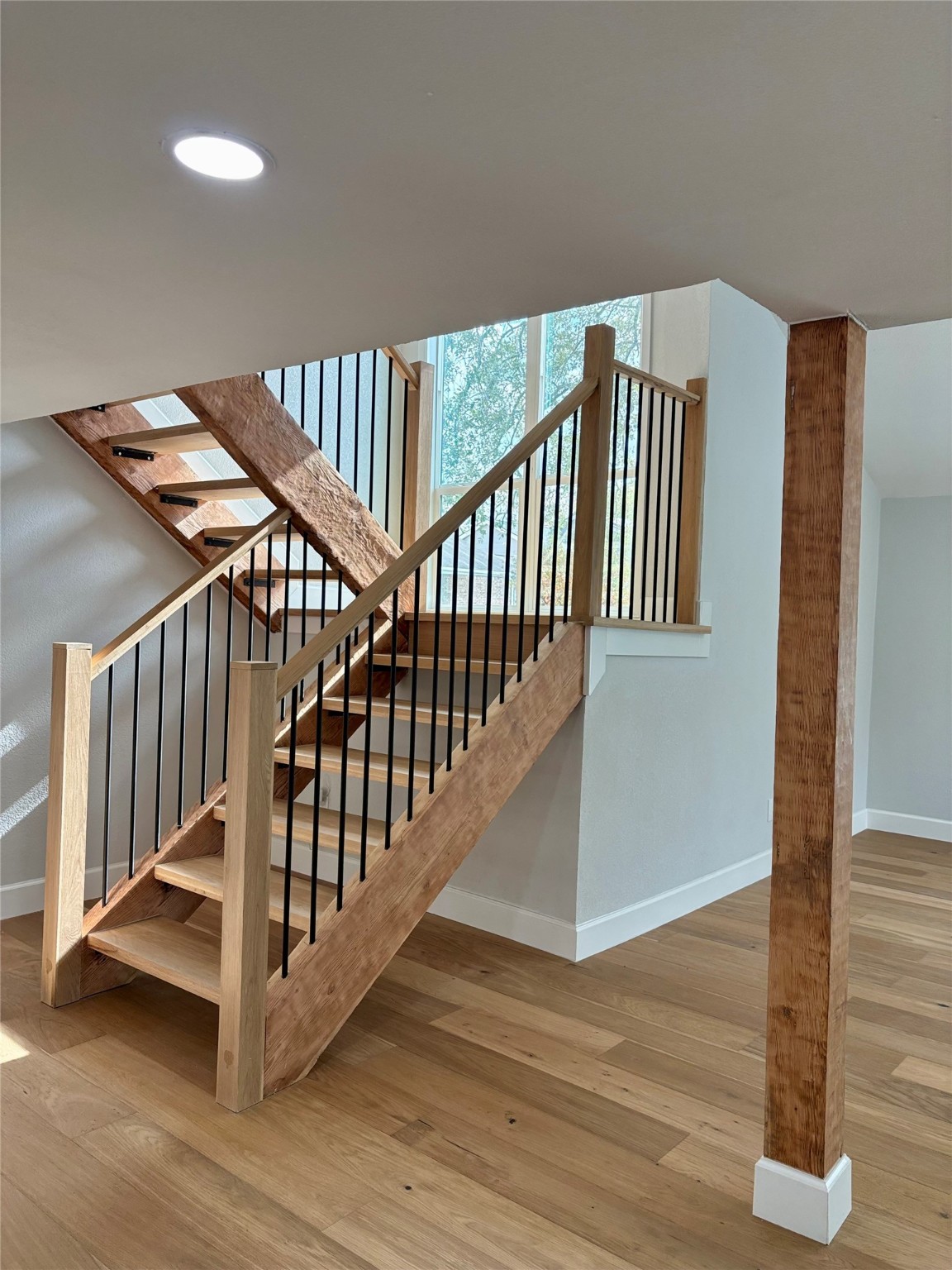 12303 Split Rail Lane Houston, TX 77071 - Photo 16 of 50 The newly built staircase features a stunning combination of cedar and white oak wood, finished in a natural clear coat that highlights the wood’s grain and craftsmanship for a warm, elegant look.