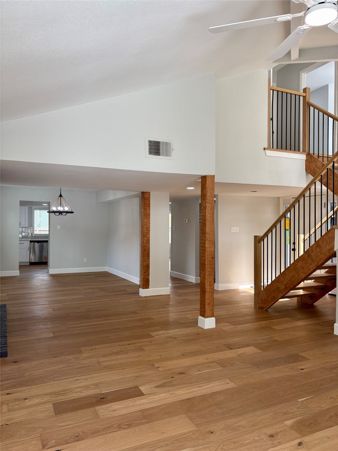 12303 Split Rail Lane Houston, TX 77071 - Photo 17 of 50 The open living space showcases fresh paint, new texture, and elegant engineered white oak flooring that seamlessly connects the living, dining, and entry areas, highlighting the home’s modern design and exceptional attention to detail.