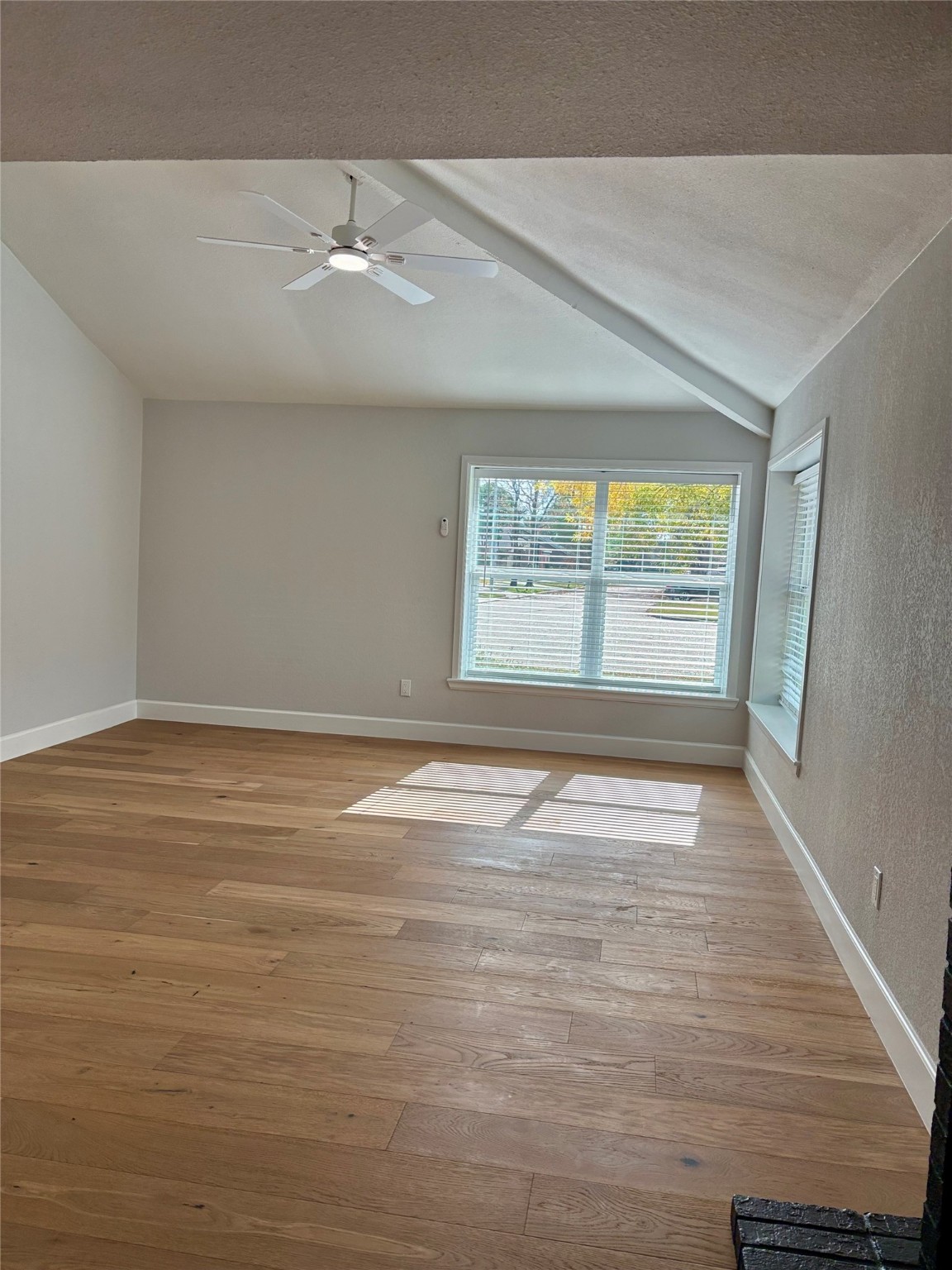 12303 Split Rail Lane Houston, TX 77071 - Photo 18 of 50 The living room offers a warm and modern atmosphere with fresh paint, new texture, and elegant engineered white oak flooring, beautifully enhanced by natural light that highlights the spacious and inviting layout.