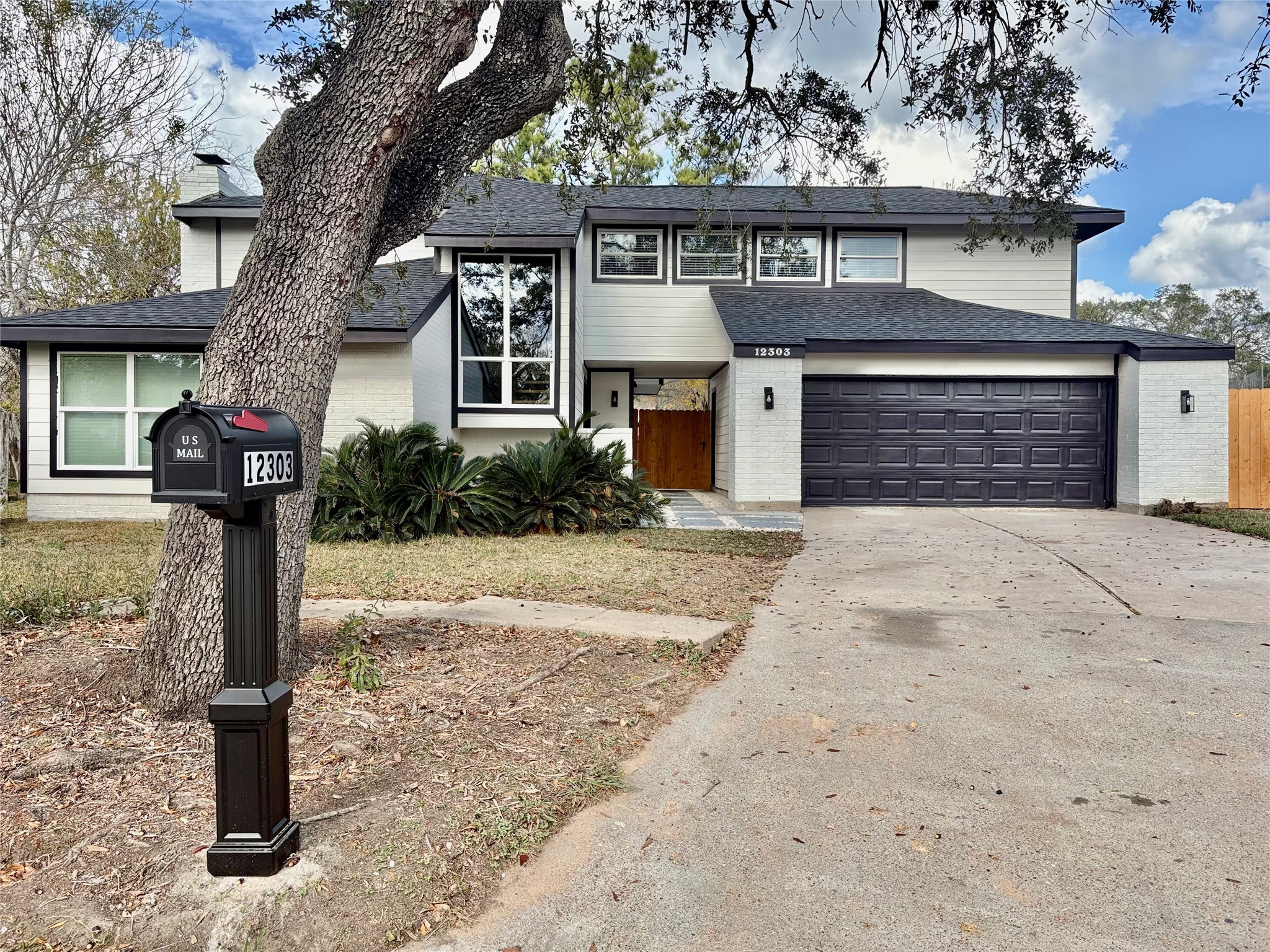 12303 Split Rail Lane Houston, TX 77071 - Photo 2 of 50 Brand new roof and new energy-efficient windows on the first floor allow abundant natural light while highlighting the home’s elegant and balanced façade.