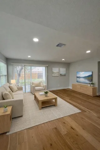 a living room with furniture and a large window