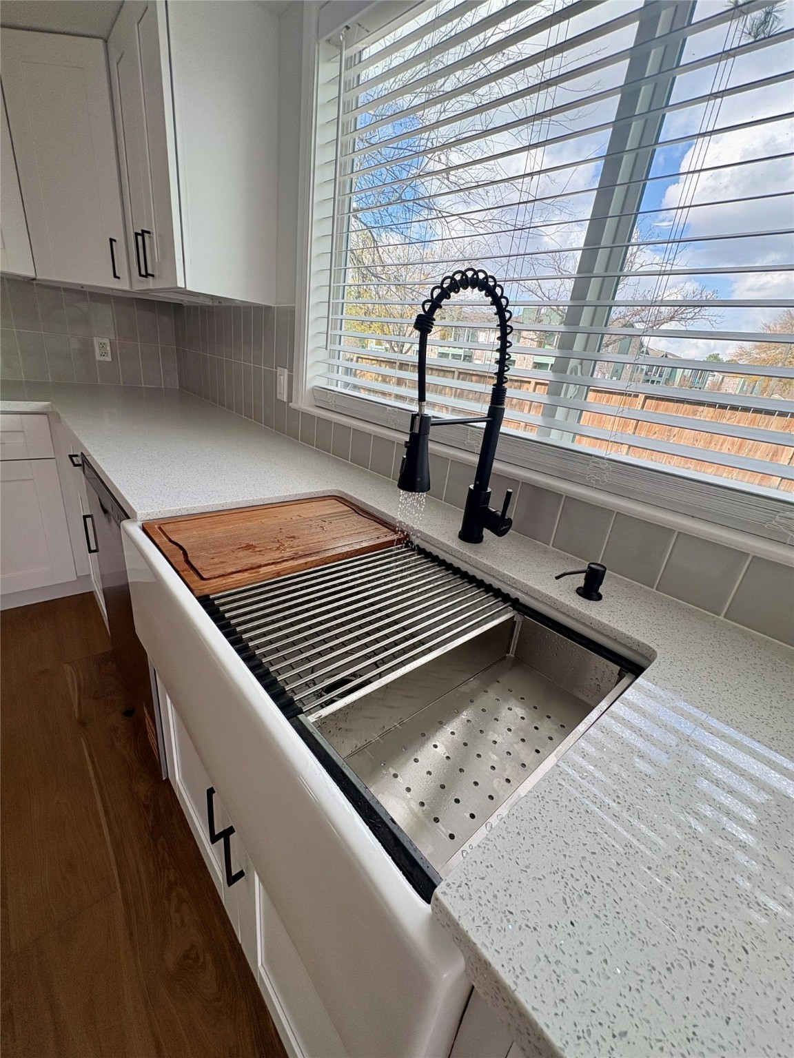 12303 Split Rail Lane Houston, TX 77071 - Photo 31 of 50 A beautiful white ceramic sink paired with a matte-black pull-down faucet creates a striking contrast and adds practical elegance to the space.