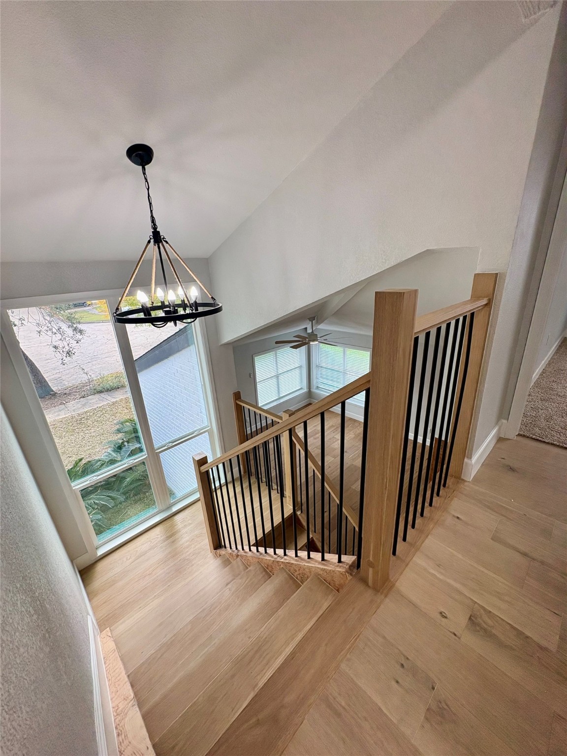 12303 Split Rail Lane Houston, TX 77071 - Photo 36 of 50 From the top of the stairs, the open layout allows a stunning view of the living area below, emphasizing the spaciousness, natural light, and seamless connection between both levels.
