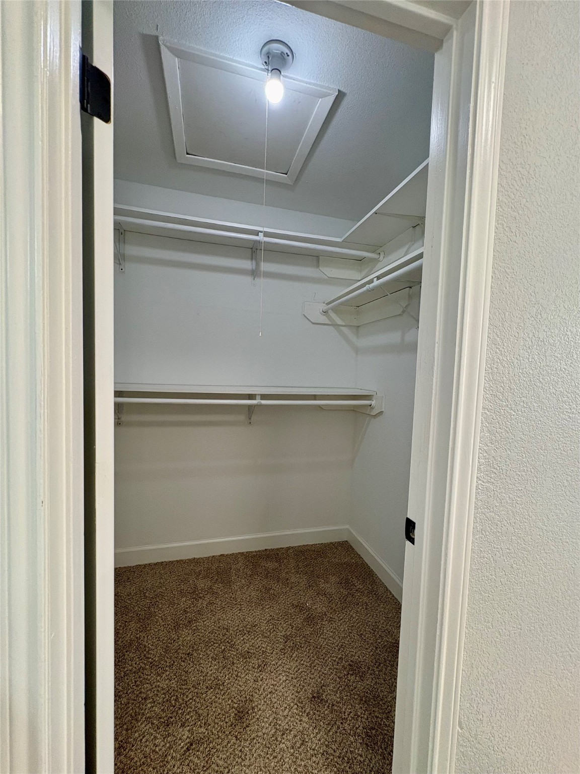 12303 Split Rail Lane Houston, TX 77071 - Photo 39 of 50 The primary closet includes a new Roman-style door, fresh paint, and new texture throughout, offering a clean, modern look with practical storage space.