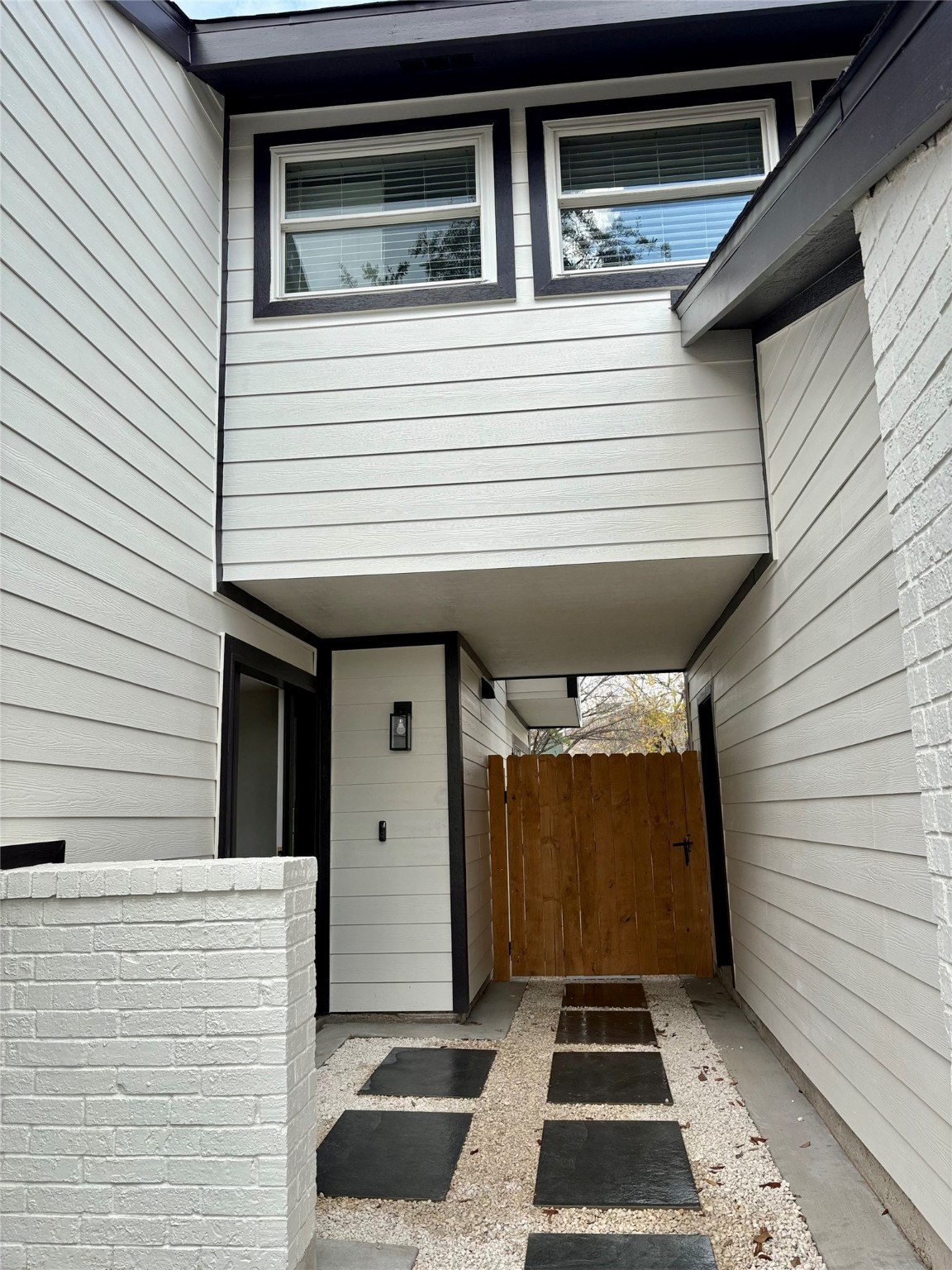 12303 Split Rail Lane Houston, TX 77071 - Photo 5 of 50 A newly crafted cedar gate enhances the property’s privacy and curb appeal, adding natural charm and strength—this home was truly built to last.