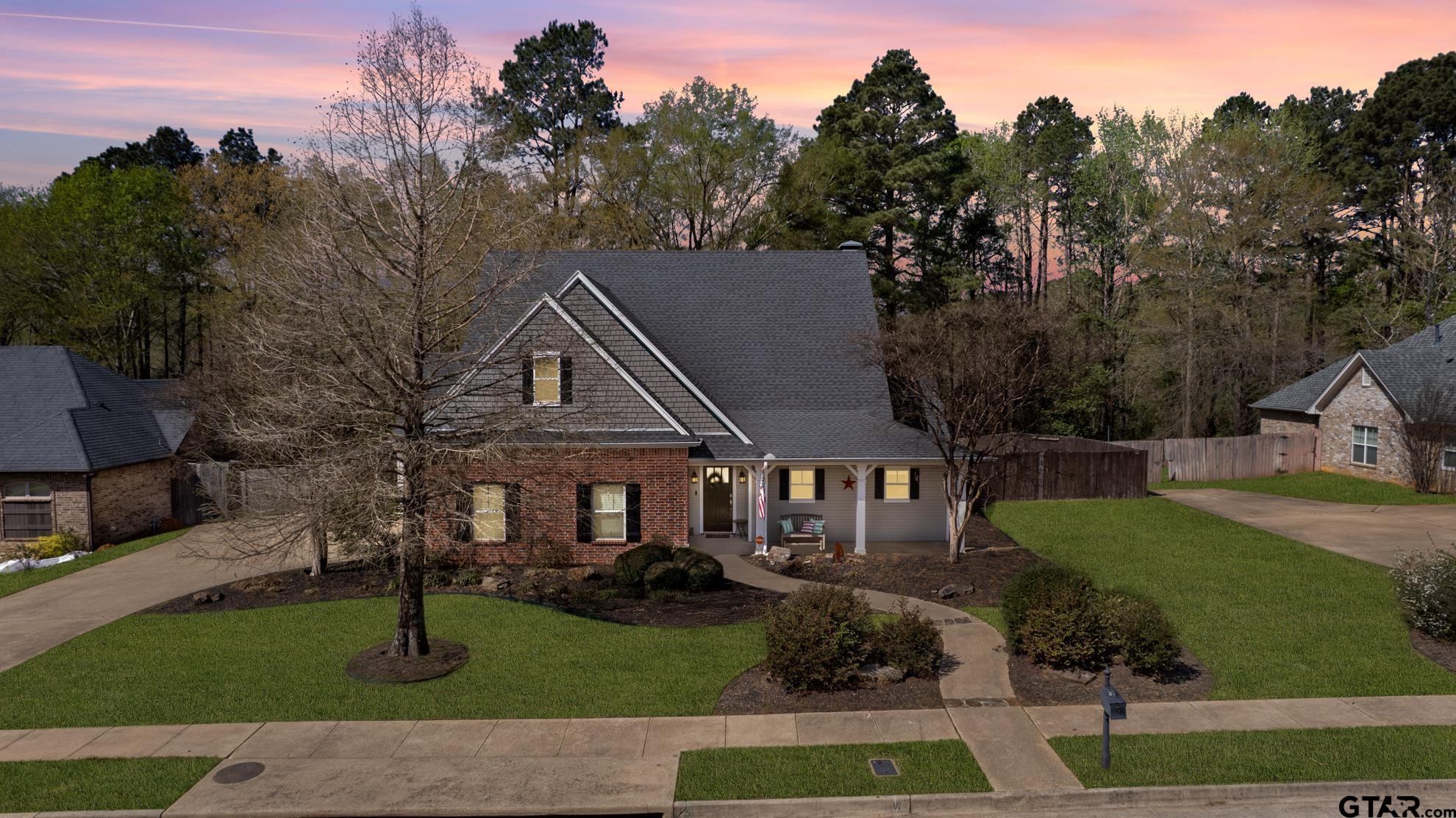 9453 Cherokee Trail Tyler, TX 75703 - Photo 1 of 40 a front view of a house with a garden