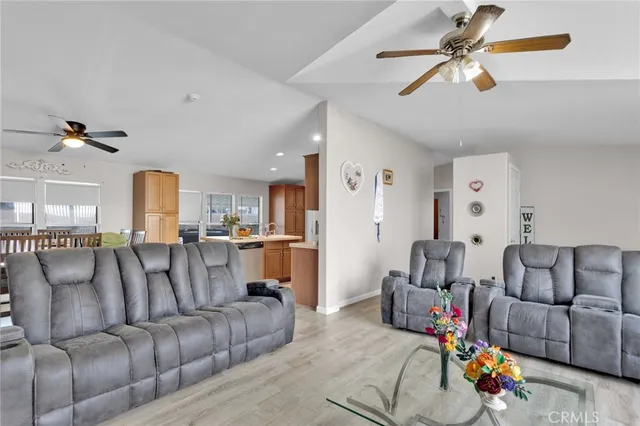 a living room with furniture and a view of kitchen