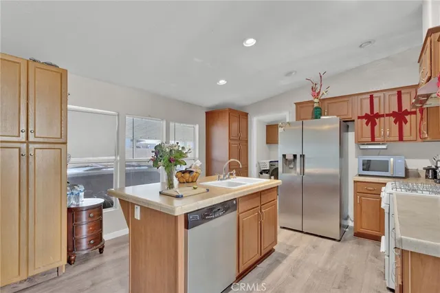 a kitchen with stainless steel appliances a sink stove and refrigerator