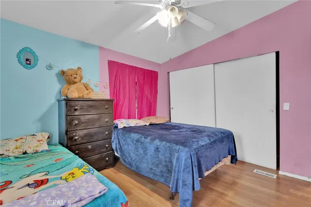 a bed room with a bed and a television