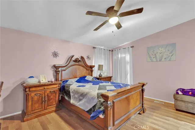 a bedroom with a bed and flat screen tv