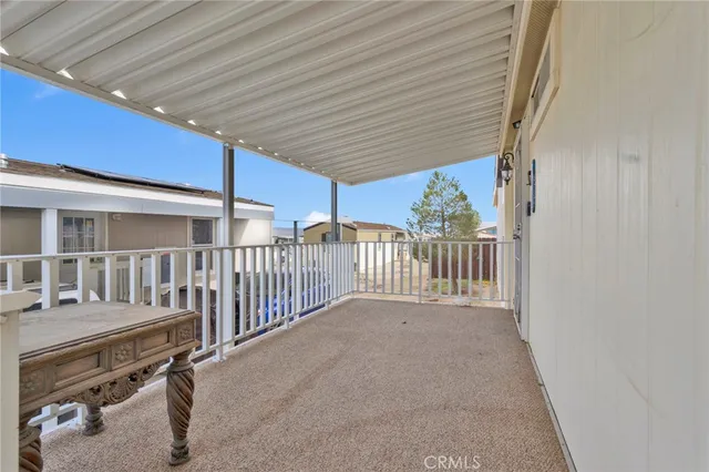 a view of a porch with wooden fence