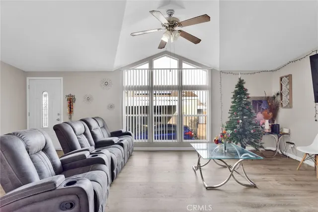 a living room with furniture a dining table and a potted plant