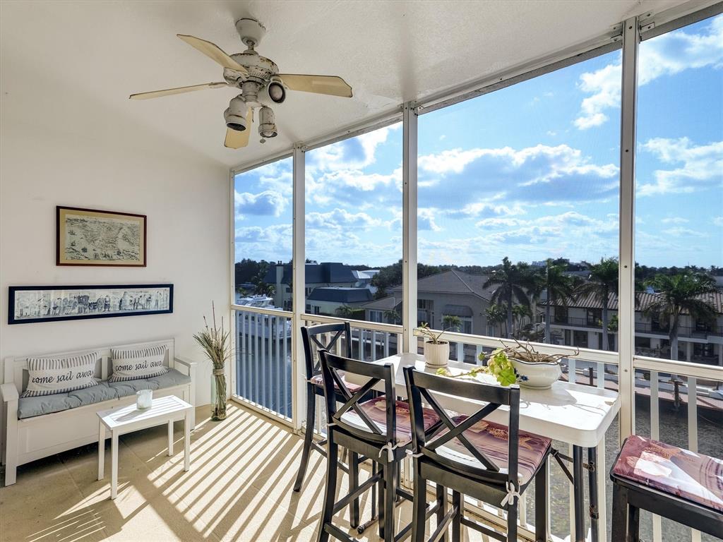 3050 Northeast 48th Court Lighthouse Point, FL 33064 - Photo 13 of 25 a living room with furniture a chandelier and a floor to ceiling window