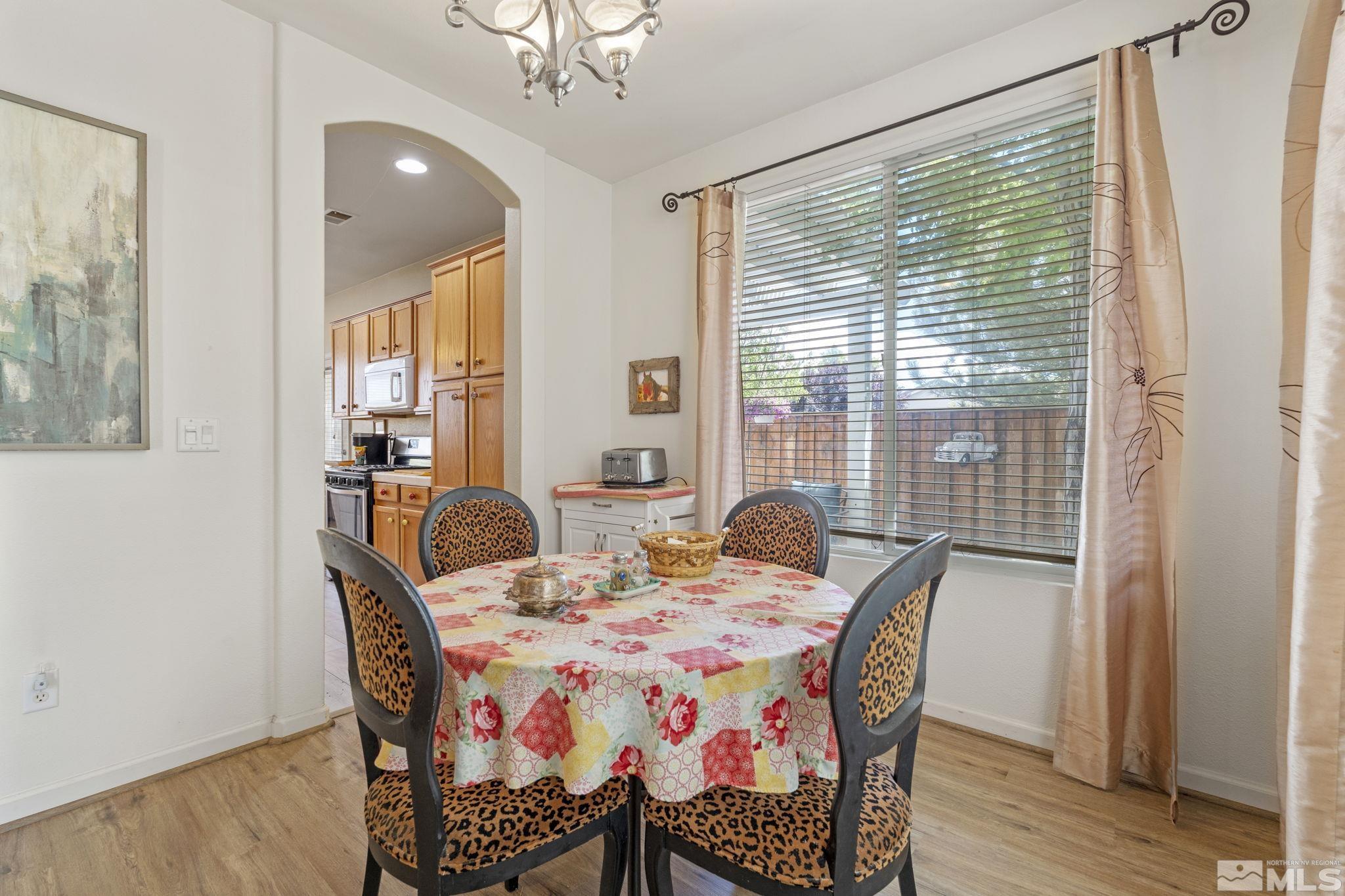 10465 Summershade Lane Reno, NV 89521 - Photo 17 of 30 a view of a dining room with furniture and wooden floor