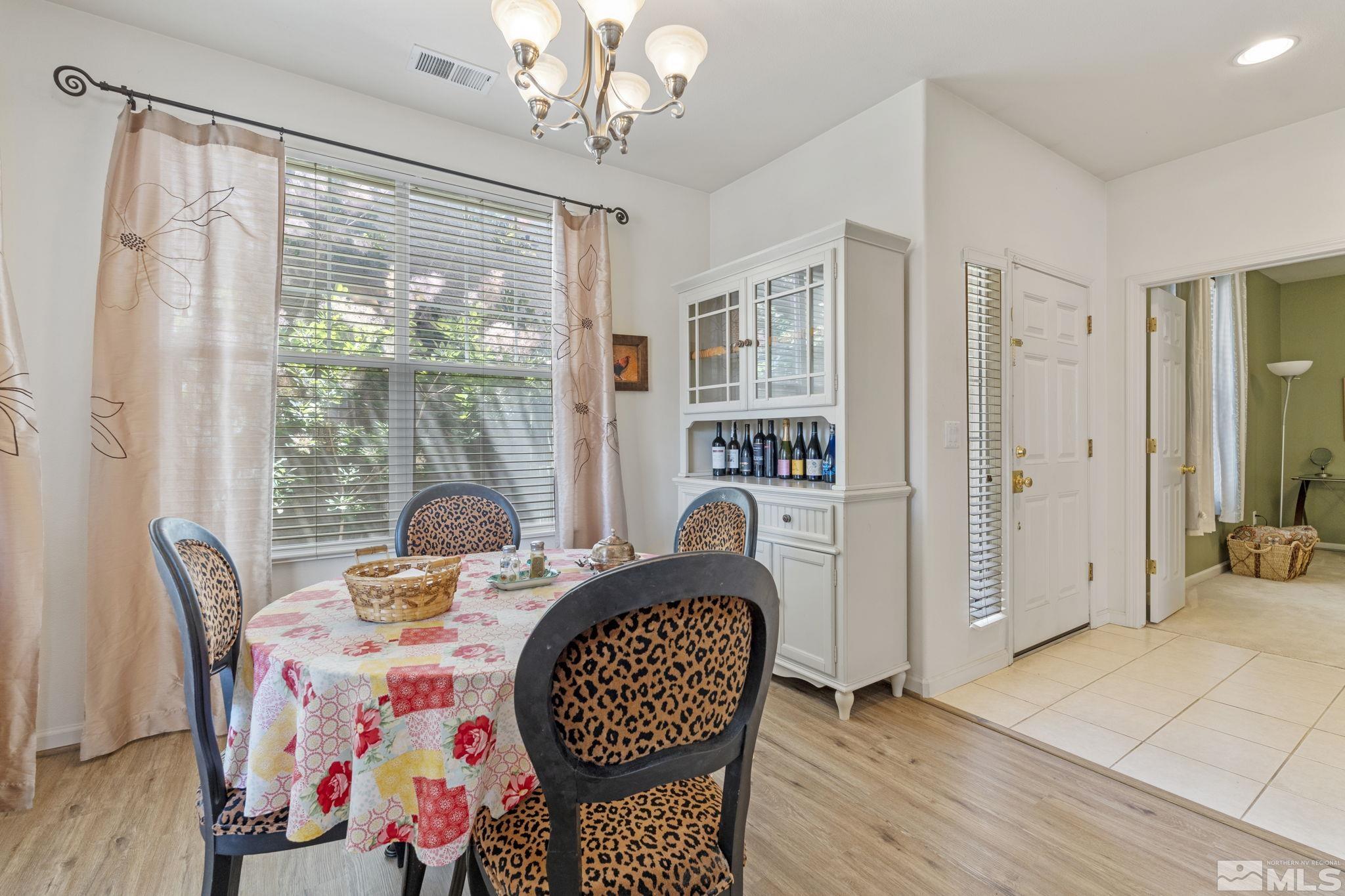 10465 Summershade Lane Reno, NV 89521 - Photo 18 of 30 a dining room with furniture a chandelier and wooden floor