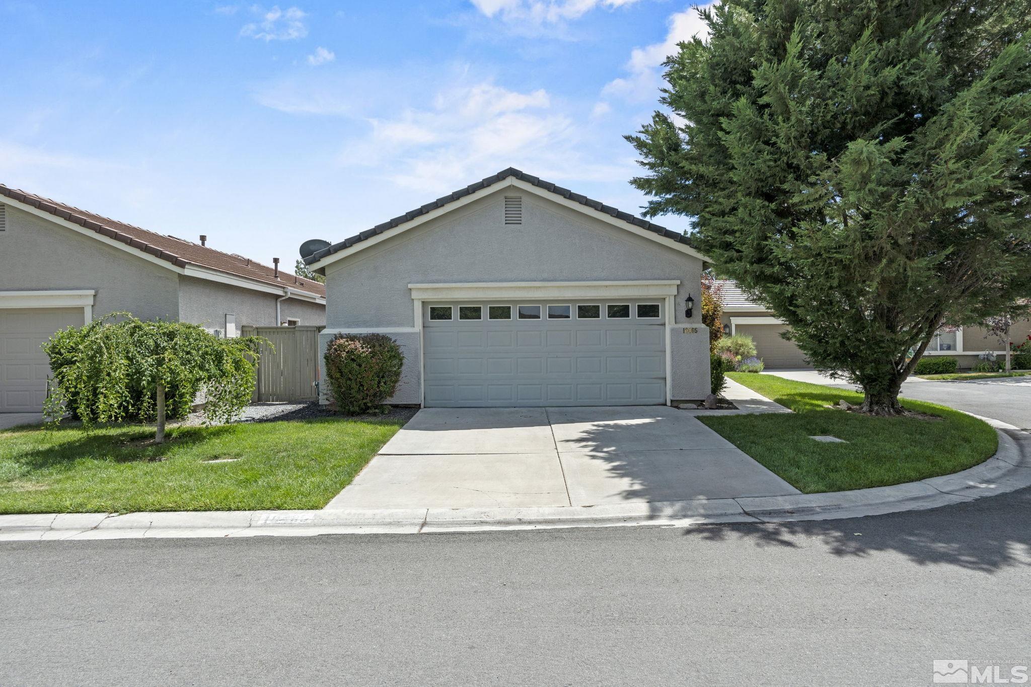 10465 Summershade Lane Reno, NV 89521 - Photo 2 of 30 a front view of a house with a yard and garage