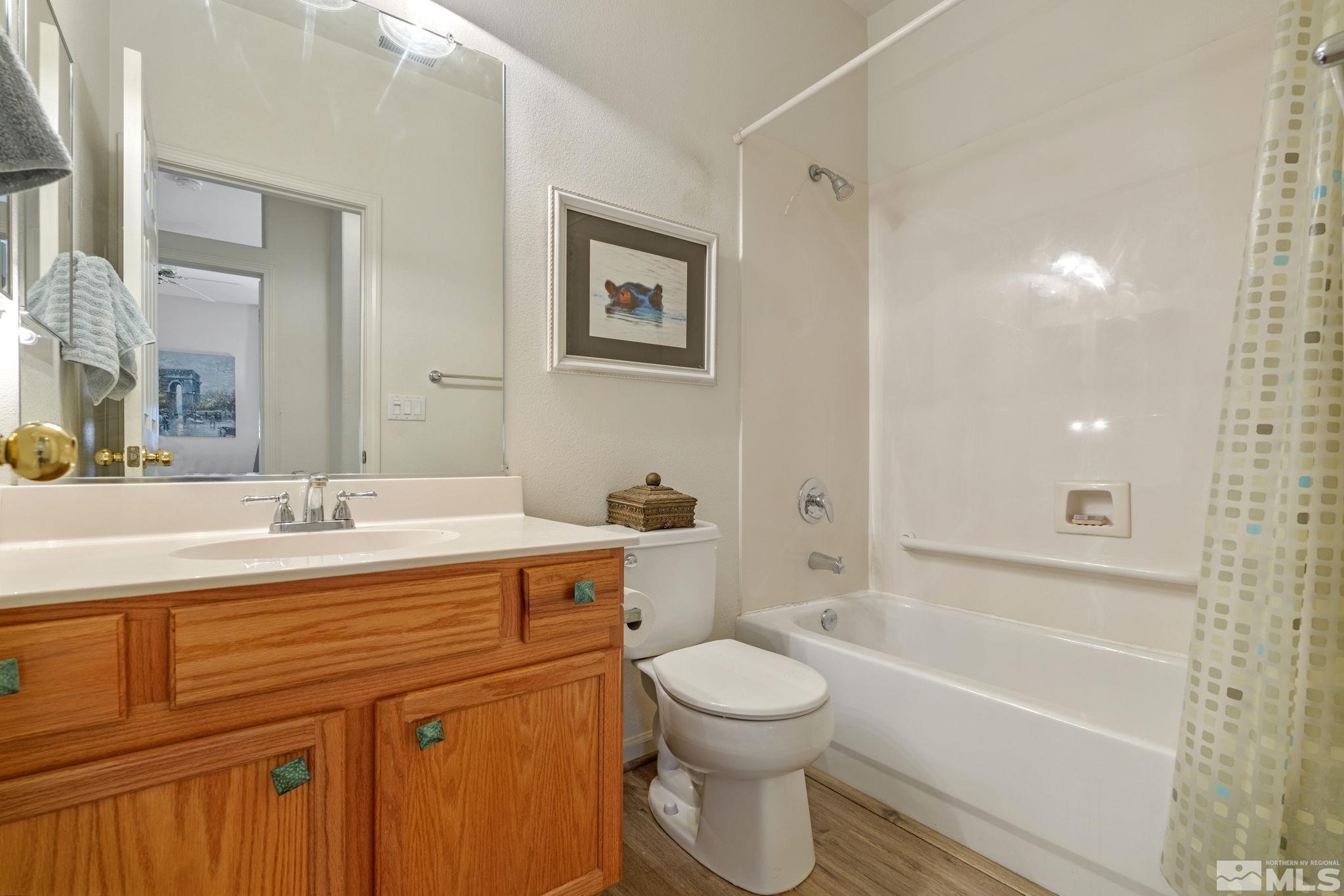 10465 Summershade Lane Reno, NV 89521 - Photo 26 of 30 a bathroom with a sink a toilet and bathtub