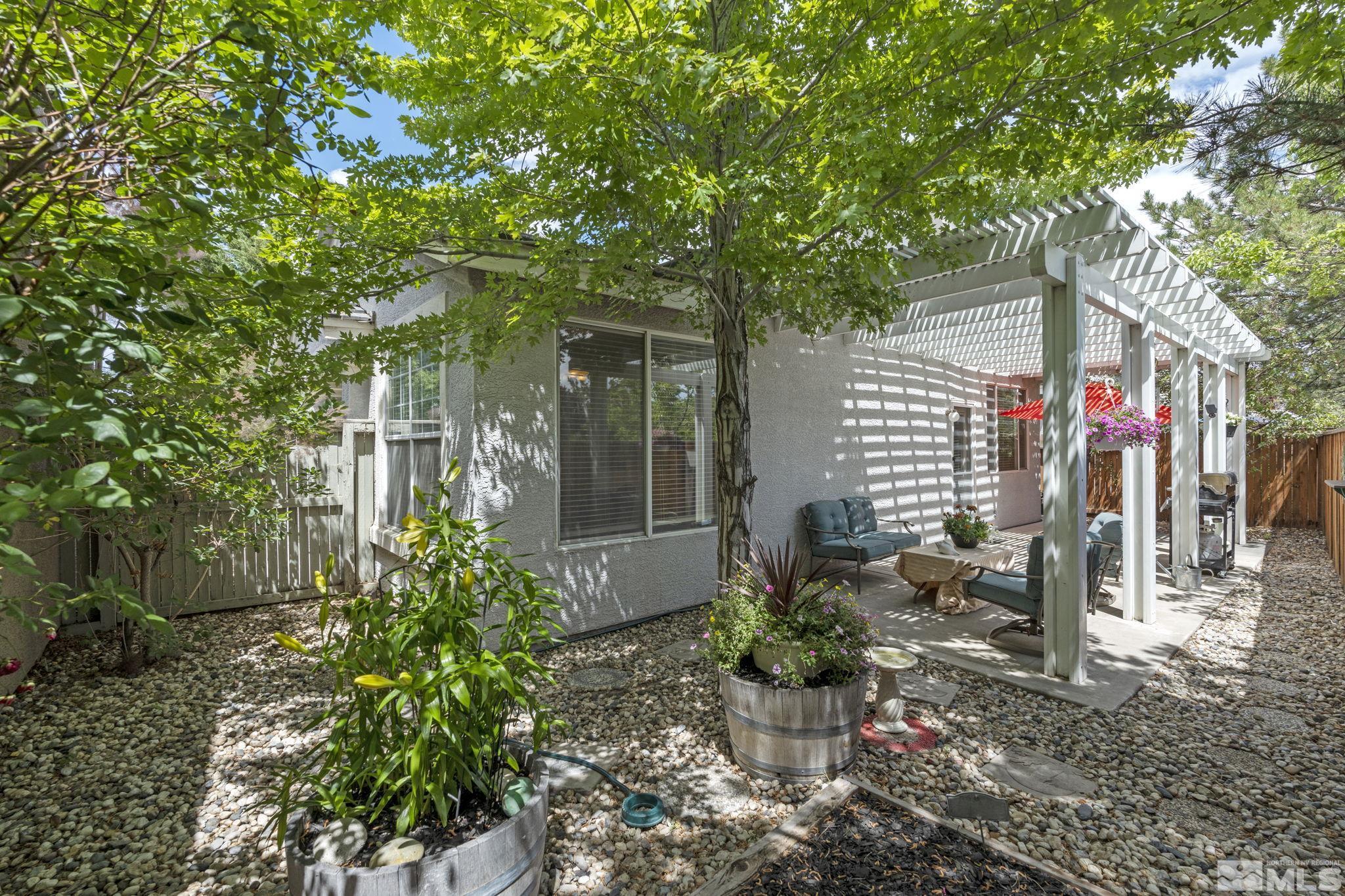 10465 Summershade Lane Reno, NV 89521 - Photo 27 of 30 a view of a patio with table and chairs and potted plants