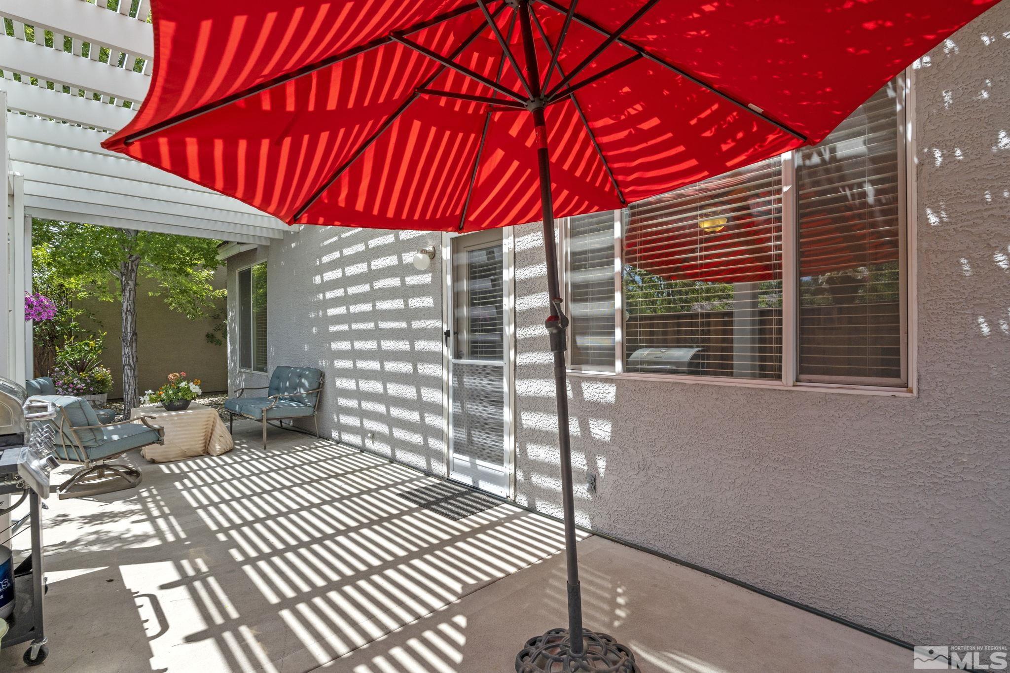 10465 Summershade Lane Reno, NV 89521 - Photo 29 of 30 a view of a patio with a table and chairs and wooden floor