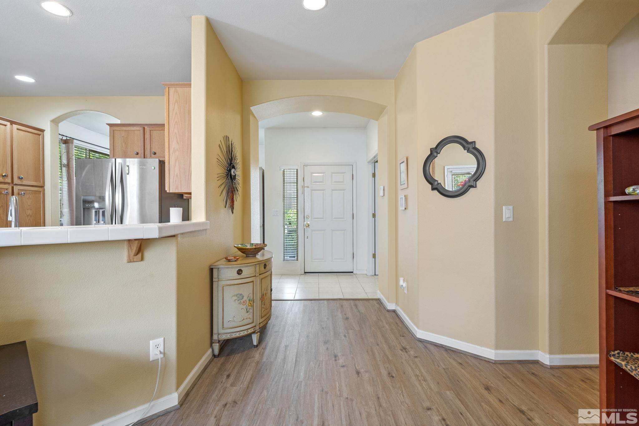 10465 Summershade Lane Reno, NV 89521 - Photo 4 of 30 a view of a hallway with wooden floor and front door