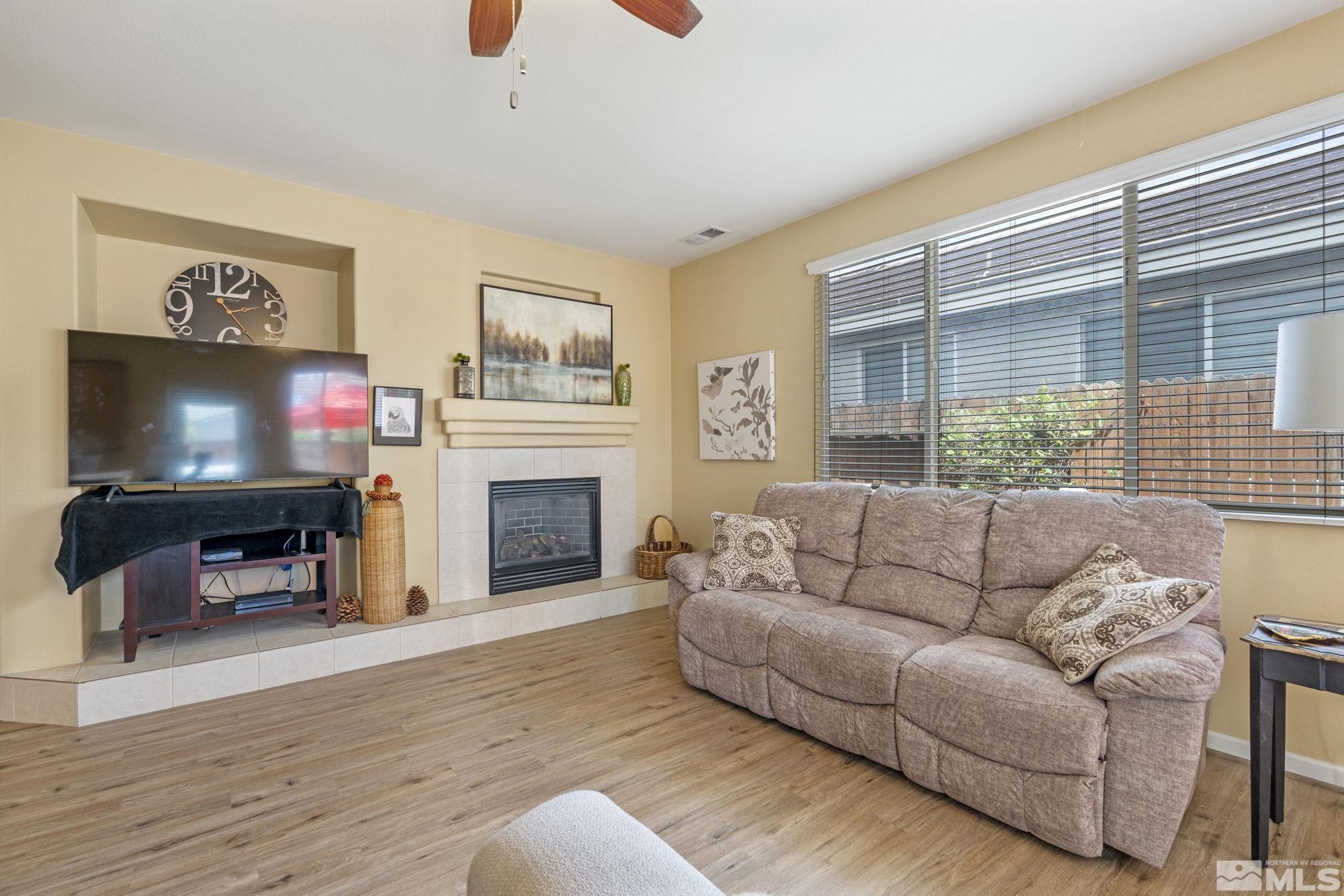 10465 Summershade Lane Reno, NV 89521 - Photo 7 of 30 a living room with furniture a flat screen tv and a fireplace