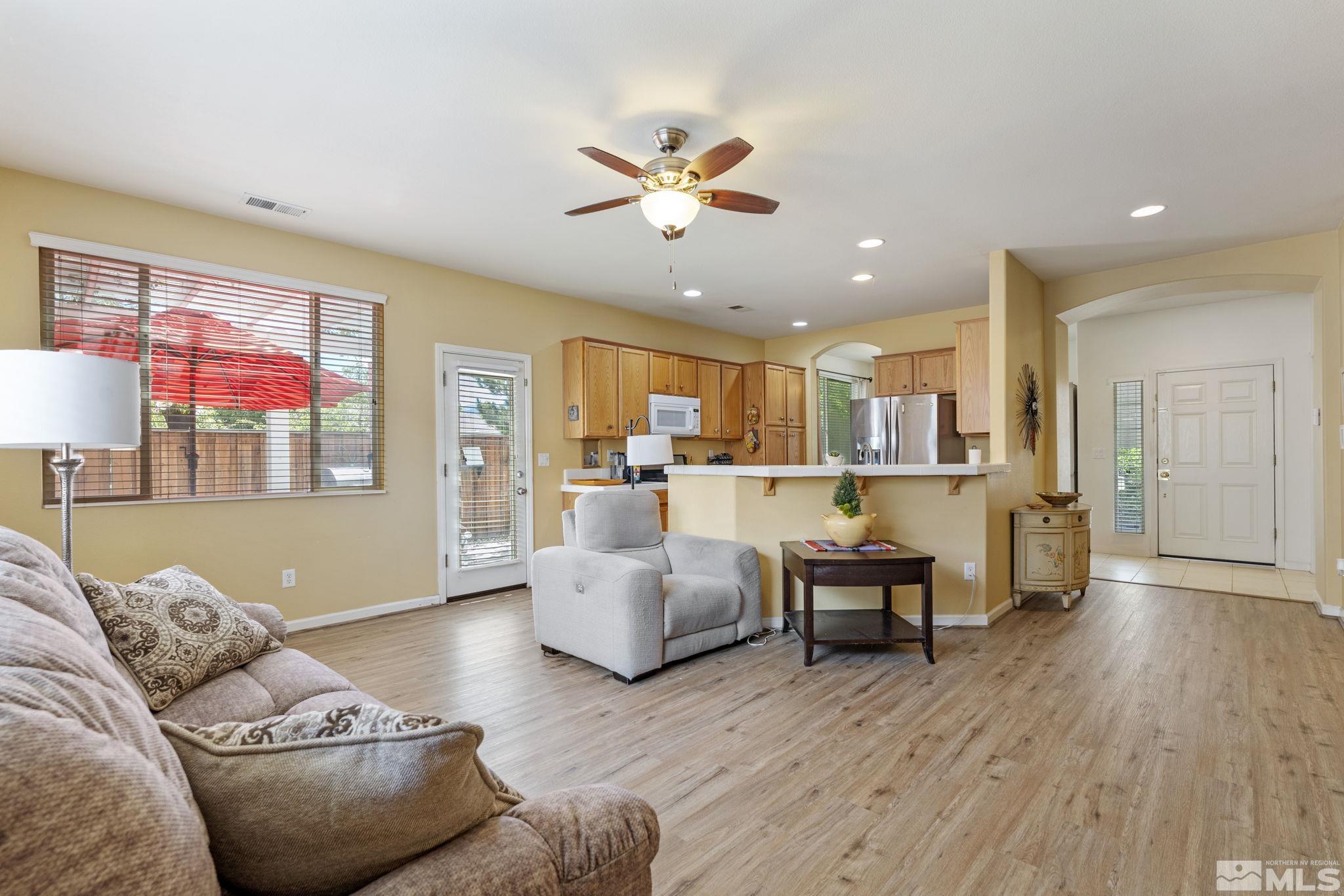 10465 Summershade Lane Reno, NV 89521 - Photo 8 of 30 a living room with furniture kitchen view and a wooden floor