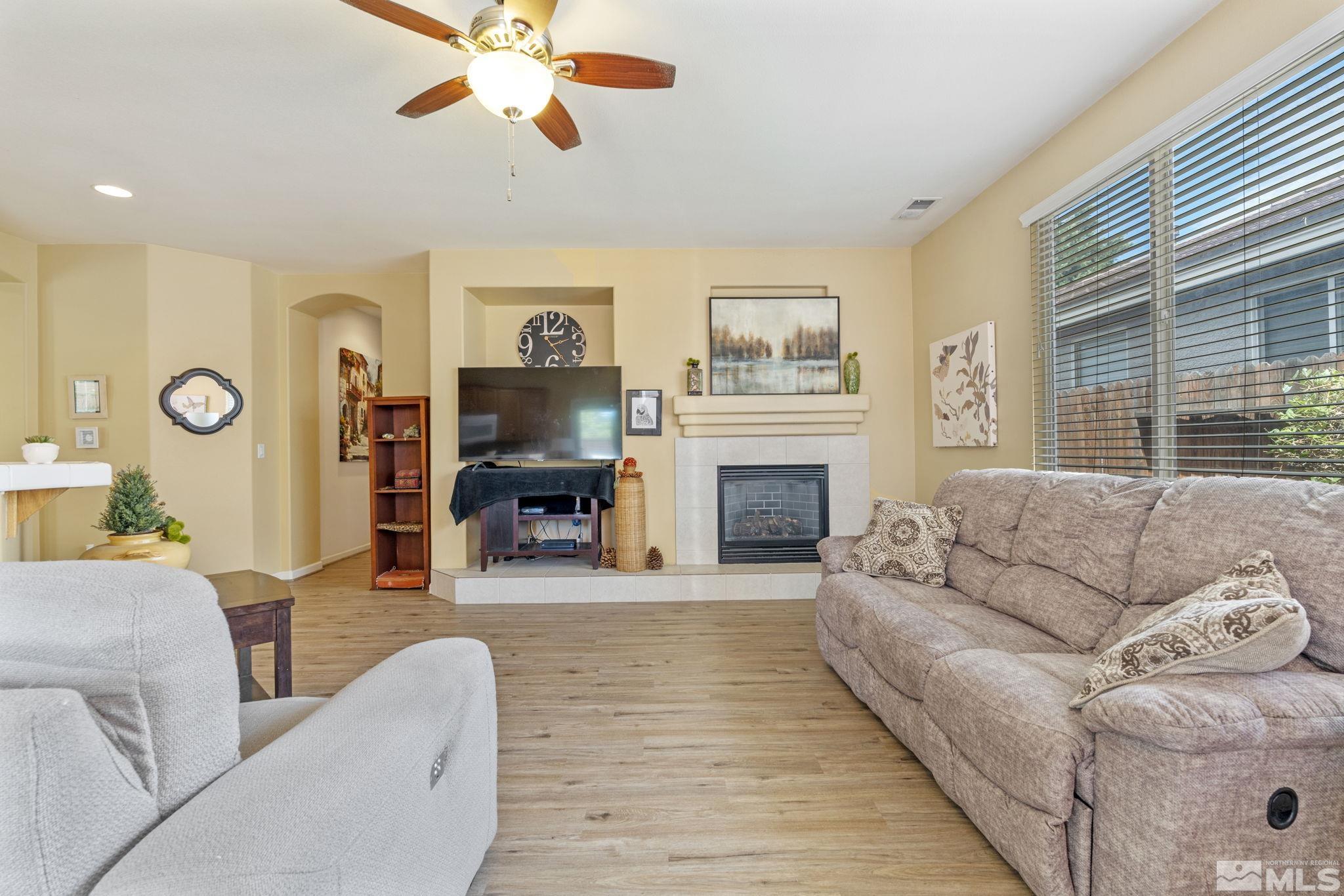 10465 Summershade Lane Reno, NV 89521 - Photo 9 of 30 a living room with furniture a fireplace and a large window