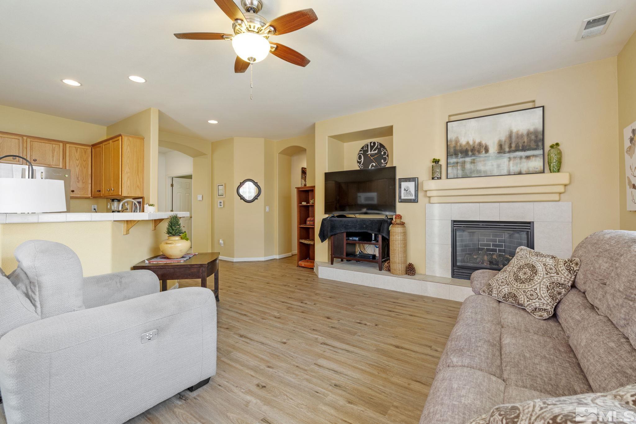 10465 Summershade Lane Reno, NV 89521 - Photo 10 of 30 a living room with furniture a fireplace and a flat screen tv