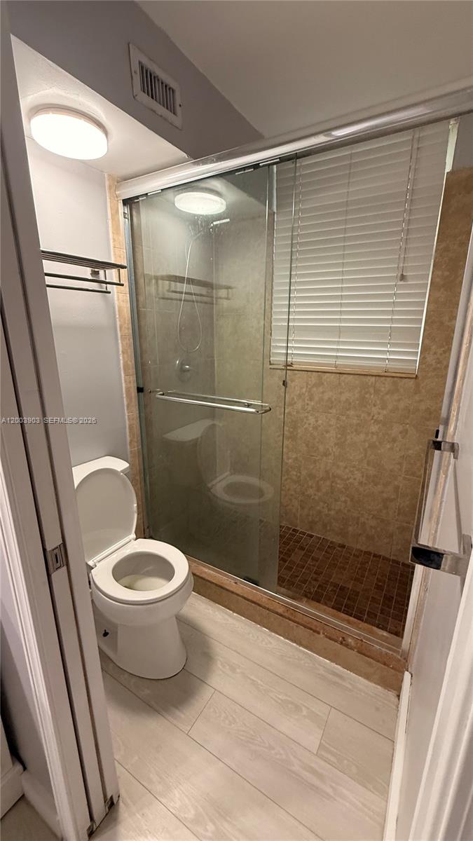 821 Lyons Road, Unit 21102 Coconut Creek, FL 33063 - Photo 10 of 17 a bathroom with a shower and a toilet