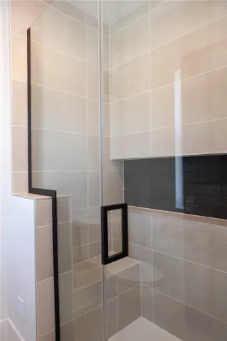 a view of a backyard with large trees and wooden fence