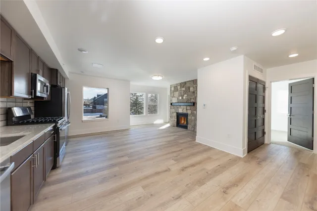 a large kitchen with stainless steel appliances granite countertop a stove and cabinets