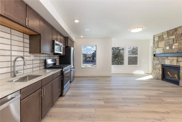 a kitchen with stainless steel appliances a refrigerator and a kitchen island